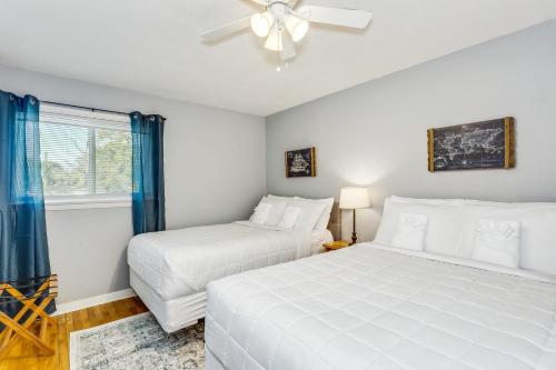 two white beds in a room with a window at Whimsical Woodland Heights Escape- COMBINED in Pensacola
