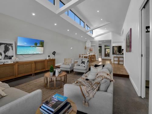 a living room with two couches and a table at Gorgeous Getaway Toowoon Bay in Long Jetty