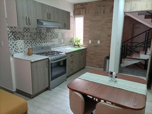 uma cozinha com um fogão e uma mesa com uma sala de jantar em Corazón y color em Oaxaca de Juárez