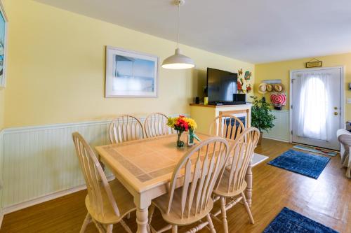 a dining room with a wooden table and chairs at Condo with Deck Walk to Beach and Convention Center! in Wildwood