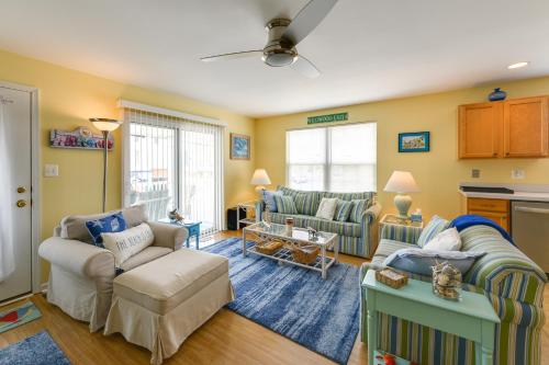 a living room with two couches and a table at Condo with Deck Walk to Beach and Convention Center! in Wildwood