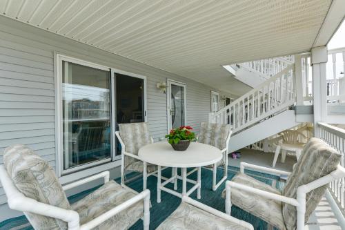 a porch with a white table and chairs at Condo with Deck Walk to Beach and Convention Center! in Wildwood