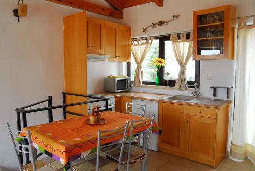 a small kitchen with a table and a microwave at Spitaki in Plakias