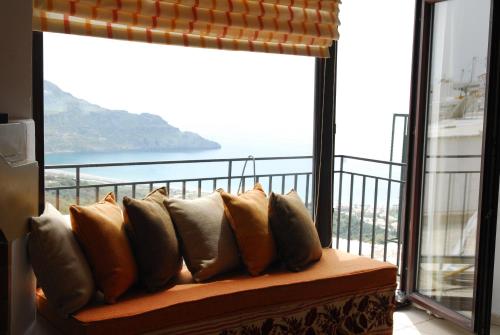 a couch sitting in front of a large window at Spitaki in Plakias