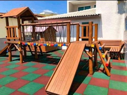a playground with a wooden bench and a gazebo at Arraial do Cabo, Vista mar, conforto, Piscina. in Arraial do Cabo