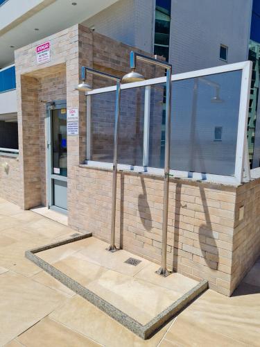 a building with a window on the side of it at Arraial do Cabo, Vista mar, conforto, Piscina. in Arraial do Cabo