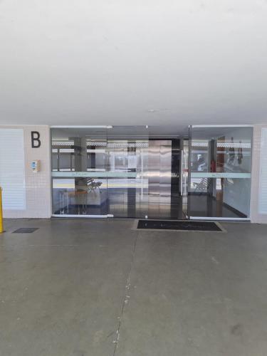an empty room with a building with a glass wall at Arraial do Cabo, Vista mar, conforto, Piscina. in Arraial do Cabo