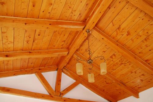 a wooden ceiling with a chandelier hanging from it at Spitaki in Plakias