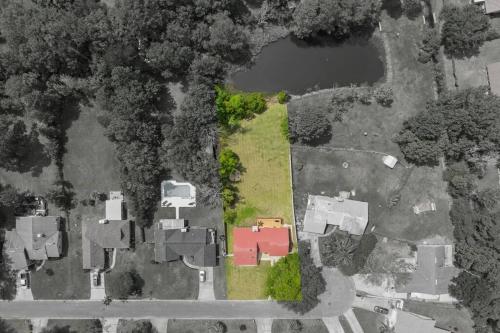 an aerial view of a yard with a red house at Spacious Home Near Beach, Large Yard, Game Room and Dog Friendly in Jacksonville