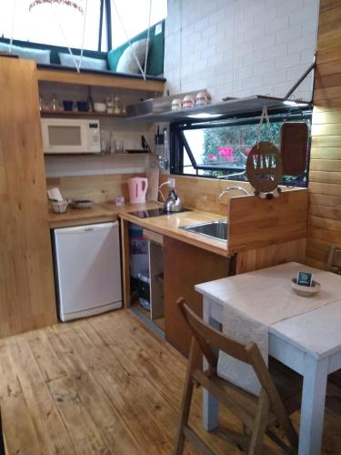 a small kitchen with a table and a sink at Modo tiny relax spa in Duggan