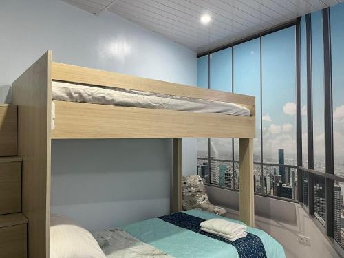 a bedroom with bunk beds with a view of the city at Quirino Hub (402-c) in Davao City