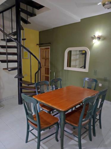 a dining room with a wooden table and chairs at Villa Sayang Humairah @ Venice of Perak Intan 2 in Lumut