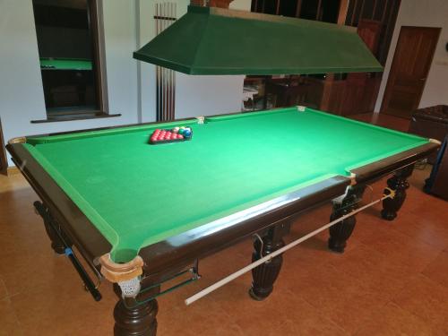 a green pool table with a cue ball on it at Meyers Hua Hin in Hua Hin