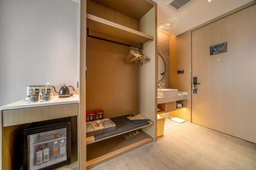 a room with a bathroom with a fireplace and a sink at Atour Hotel Wuxi New District Nanchan Temple Scenic Area in Wuxi