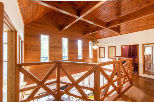 a large room with wooden ceilings and wooden flooring at S-villa Nasu Audrey in Nasu