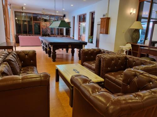 a living room with couches and a pool table at Meyers Hua Hin in Hua Hin
