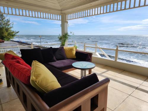 a living room with a couch and a view of the ocean at Baan Soulmates in Ban Khung Tanot