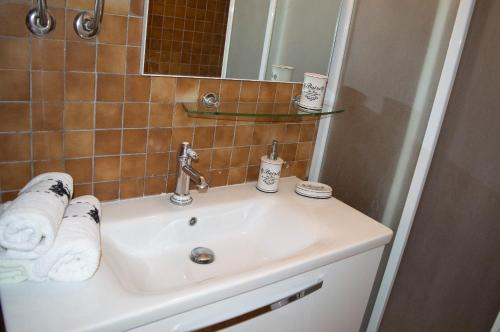 a bathroom with a white sink and a mirror at Apartment Ela - very close to beach in Rogač