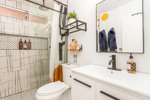 a bathroom with a toilet and a sink and a shower at Hot Tub, Games, King Bed, Fire Pit, BBQ Grill, minutes from National Park and Views in Joshua Tree