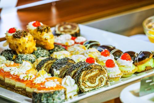 a tray filled with different types of pastries and desserts at Xenios Possidi Paradise Hotel in Possidi