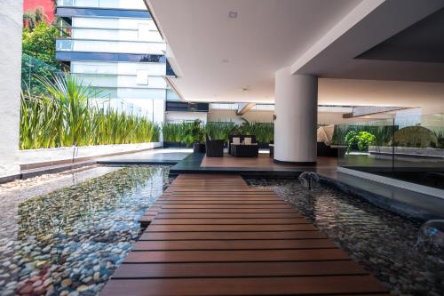 a lobby of a building with a pool of water at Condesa Luxury Lofts 1510 in Mexico City