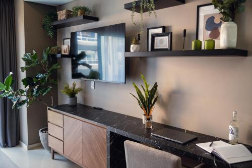 an office with a desk with a laptop and plants at Condesa Luxury Lofts 1510 in Mexico City