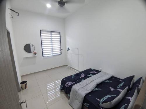 a white room with a bed and a window at Cikgu I&S Homestay in Jitra