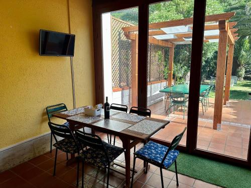 a dining room with a table and chairs and a patio at Villa la caletta in Maiori