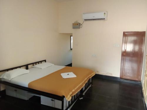 a bedroom with a bed in a room with a window at Heritage Bagala VIP Suite in Puri