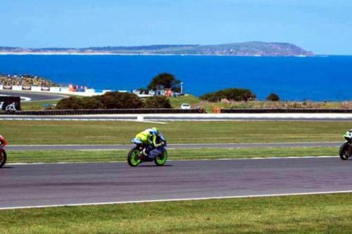 a group of people riding motorcycles on a race track at Blue Bay View Surf & Sauna Stay in Surf Beach