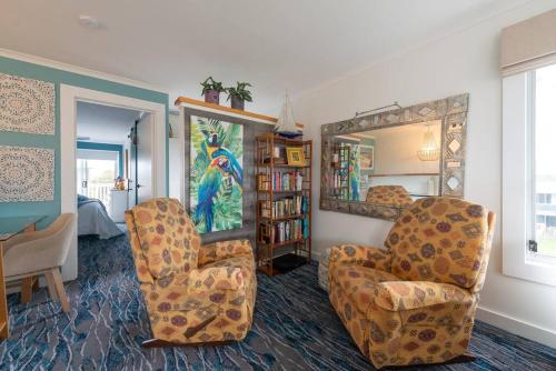 a living room with two chairs and a mirror at Blue Bay View Surf & Sauna Stay in Surf Beach