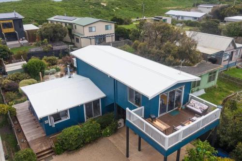 an overhead view of a blue house with a white roof at Blue Bay View Surf & Sauna Stay in Surf Beach