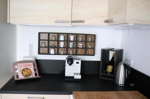 a kitchen with a counter top with a bottle of wine at Haus 16 Ferienhaus zwischen Salzburg Chiemsee und Waging am See in Kirchanschöring