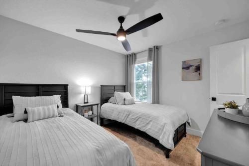 a bedroom with two beds and a ceiling fan at SideB#JaxBeachRetreat w/Gameroom and BackyardOasis in Jacksonville Beach