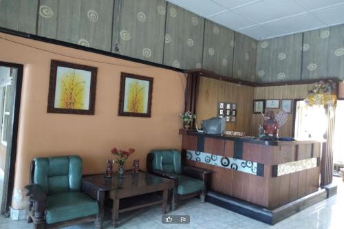 a waiting room with two chairs and a table at DK Hotel Singaraja in Singaraja