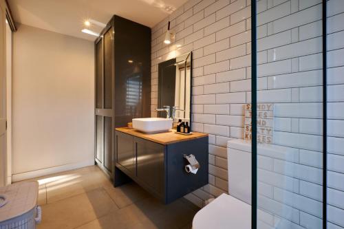 a bathroom with a sink and a toilet at Peaceful Tree Cottage in Tamarin