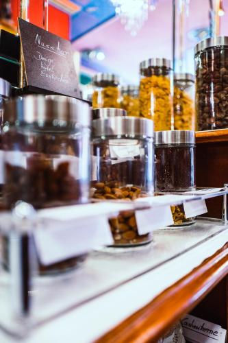 a counter with jars of honey on it at Design Hotel Euskirchen in Euskirchen