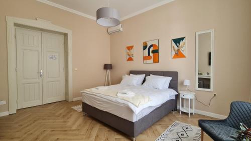a bedroom with a bed and a chair at Urban Haven in Subotica