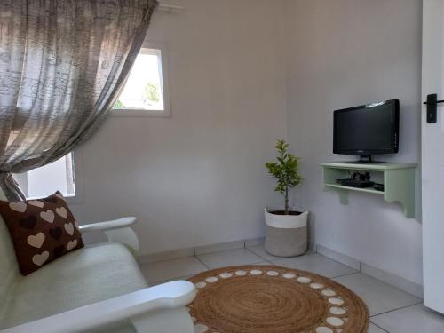 a living room with a couch and a tv at Lemon Tree Manor- Country Cottage in Groblersdal