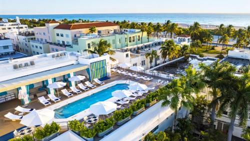 an aerial view of a resort with a pool and the ocean at 4 RM on Beach SoBeSuites by AmericanVacationLiving in Miami Beach