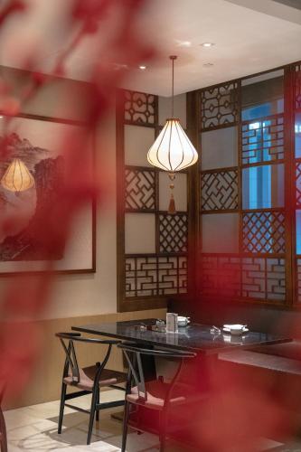 a dining room with a table and some stained glass at Hyatt Regency Xiamen Wuyuanwan in Xiamen