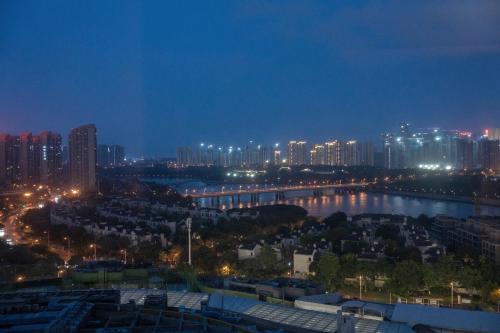 a city skyline at night with a river and buildings at Hyatt Regency Xiamen Wuyuanwan in Xiamen