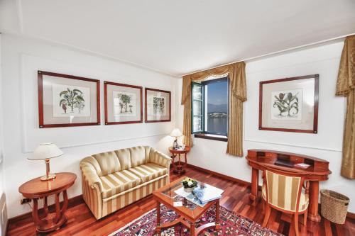 a living room with a couch and a table at Relais Casali della Cisterna in Belgirate