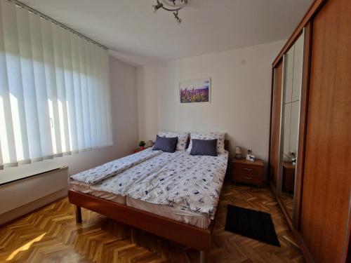 a bedroom with a large bed with blue pillows at Apartment Sole Dorato in Rijeka