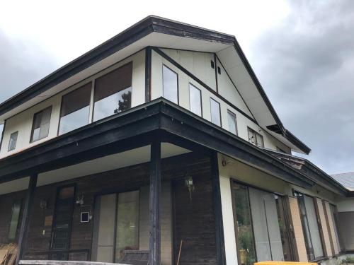 a house with glass windows on the front of it at Cool Villa Hida Resort - Vacation STAY 16761v in Hida