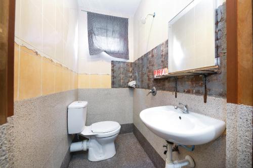 a bathroom with a toilet and a sink at OYO 210 Hotel Five 2 in Kota Kinabalu