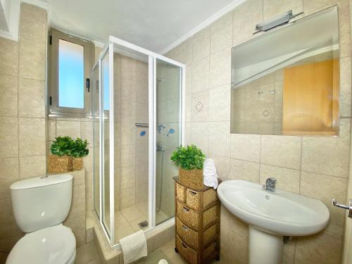 a bathroom with a toilet and a sink and a shower at Villa Julia in Sani Beach