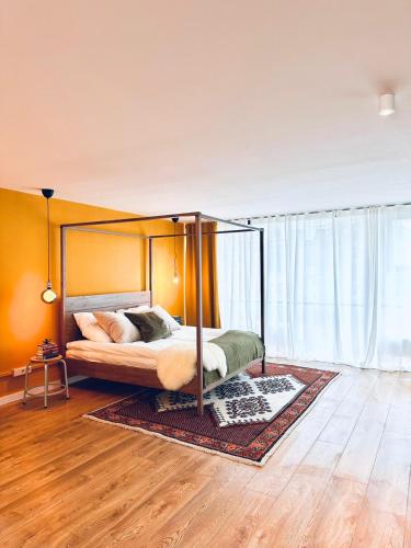 a bedroom with a canopy bed and a wooden floor at Lofts V26 in Essen