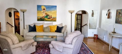 a living room with two chairs and a couch at Apartment in the heart of Cotignac in Cotignac