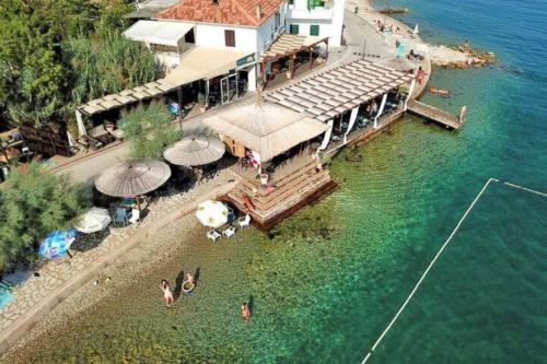an aerial view of a house on a dock in the water at Penthouse Petra with hot tub in Kali